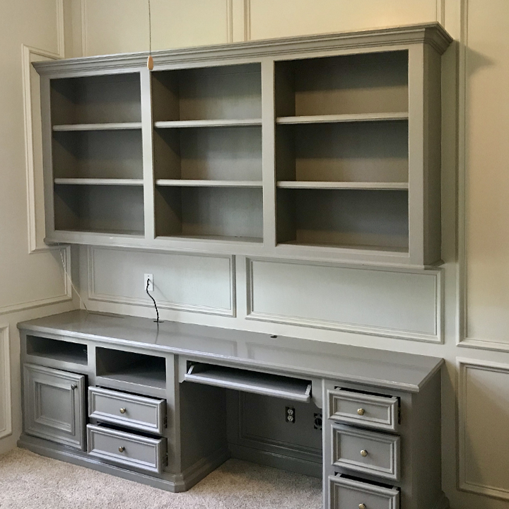 Renovated home office cabinets painted in modern grey, with updated hardware and a sleek finish.