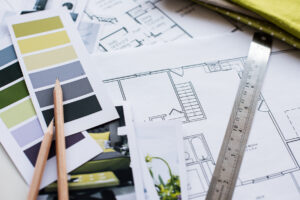 Graphic illustration that includes paint swatches, ruler, architectural drawings, and pencils