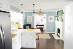 Picture of a stylish kitchen with blue walls and white cabinetry.
