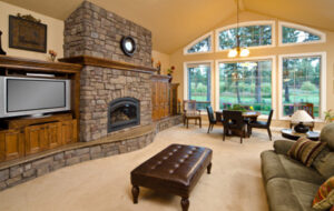 Picture of the interior of a recently painted living room with a large fireplace.