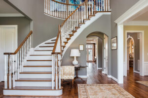 Picture of a recently painted entryway with a large curved staircase.